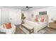 Bright bedroom features a ceiling fan, a neutral color palette, a bench, and an area rug at 1091 Pine St, Conyers, GA 30012