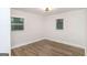 Bright bedroom with wood floors, white walls, and two windows providing ample natural light at 1091 Pine St, Conyers, GA 30012