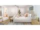 Well-lit bedroom with a neutral color palette features a sitting area, a bench, and luxury vinyl flooring at 1091 Pine St, Conyers, GA 30012