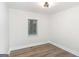 Bright bedroom featuring a ceiling light, neutral colors, and luxury vinyl flooring at 1091 Pine St, Conyers, GA 30012