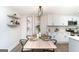 Stylish dining area featuring modern lighting, seating for six, and a view into the updated kitchen at 1091 Pine St, Conyers, GA 30012