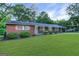 Charming home with a brick facade, manicured landscaping, and inviting covered porch at 1091 Pine St, Conyers, GA 30012