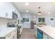 Bright kitchen features white cabinets, stainless steel appliances, quartz countertops, and modern pendant lighting at 1091 Pine St, Conyers, GA 30012