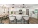 Modern kitchen island with white countertops, stylish bar stools, and stainless steel appliances at 1091 Pine St, Conyers, GA 30012