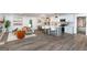Open-concept living area featuring wood flooring, a modern kitchen, and a comfortable seating area at 1091 Pine St, Conyers, GA 30012