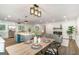 Bright open-concept living space with a dining area, modern kitchen, and cozy seating arrangement at 1091 Pine St, Conyers, GA 30012