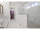 Bright bathroom features white cabinets, marble floors, glass shower, and a walk-in closet at 405 Bandon Way, Peachtree City, GA 30269