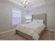 Cozy bedroom with plush carpeting, a tray ceiling, and a comfortable upholstered bed at 405 Bandon Way, Peachtree City, GA 30269