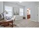 Bright bedroom with a large window, desk and neutral carpet, flowing into ensuite bath at 405 Bandon Way, Peachtree City, GA 30269
