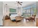 Bright bedroom featuring a ceiling fan, hardwood floors, a sitting area and a large window at 405 Bandon Way, Peachtree City, GA 30269