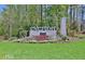 Welcoming entrance to Everton, showcasing beautiful landscaping and a stone monument sign at 405 Bandon Way, Peachtree City, GA 30269