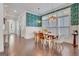 Bright, open dining area featuring stylish lighting, hardwood floors, and views to the outdoors at 405 Bandon Way, Peachtree City, GA 30269