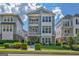 Charming three-story home with manicured lawn, lush bushes, and a welcoming facade at 405 Bandon Way, Peachtree City, GA 30269