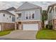 Charming two-story home with a brick base, blue siding, and a covered porch at 405 Bandon Way, Peachtree City, GA 30269