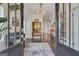 Grand foyer with hardwood floors, stylish chandelier, and vintage hutch at 405 Bandon Way, Peachtree City, GA 30269