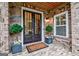 Inviting entryway with elegant double doors, manicured plants, and brick accents at 405 Bandon Way, Peachtree City, GA 30269