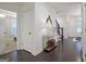 Inviting hallway with hardwood floors, decorative table, and staircase leading to the upper level at 405 Bandon Way, Peachtree City, GA 30269
