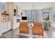 Bright living room boasts a stone fireplace, hardwood floors, and large windows, offering great natural light at 405 Bandon Way, Peachtree City, GA 30269