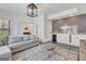 Open-concept living room with a gray sofa and a stylish bar area at 405 Bandon Way, Peachtree City, GA 30269