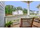View of the neighborhood from a porch with wood rocking chairs and white columns at 405 Bandon Way, Peachtree City, GA 30269
