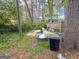 Backyard view featuring grass, foliage, trees, and a fence at 5637 Sturbridge Way, South Fulton, GA 30349