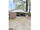 Wide shot of an exterior carport with brick wall and a concrete floor at 5637 Sturbridge Way, South Fulton, GA 30349