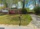 Charming split-level home with brick facade, red shutters and a well-maintained driveway at 5637 Sturbridge Way, South Fulton, GA 30349