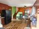 Cozy kitchen with classic appliances, wood paneling, and an open floor plan leading to the stairs at 5637 Sturbridge Way, South Fulton, GA 30349