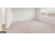 Large bedroom with plush carpeting and a view from a large window at 8504 Polston Pl # 145, Douglasville, GA 30134
