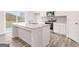 Modern kitchen with white cabinets, stainless steel appliances, and granite countertops, with wood-style floors at 8504 Polston Pl # 145, Douglasville, GA 30134