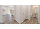 Hallway view leading to a bathroom with wood-look floors, and access to another room at 8501 Polston Pl # 143, Douglasville, GA 30134