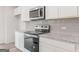 Modern kitchen with granite countertops, stainless steel appliances, and bright subway tile backsplash at 8501 Polston Pl # 143, Douglasville, GA 30134