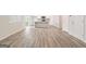 Open-concept living area with wood-look floors and easy access to kitchen and large windows at 8501 Polston Pl # 143, Douglasville, GA 30134