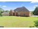 Large, well-maintained backyard with a wrought iron fence surrounding a brick home at 1010 Elaine Ct, Mcdonough, GA 30252