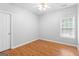 A bedroom featuring a window, ceiling fan and neutral paint and hardwood flooring at 1010 Elaine Ct, Mcdonough, GA 30252
