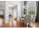 The dining area features natural light, a decorative chandelier, and hardwood floors at 1010 Elaine Ct, Mcdonough, GA 30252