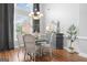 Bright dining area with tall windows, hardwood floors, and stylish decor at 1010 Elaine Ct, Mcdonough, GA 30252