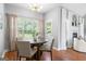 Bright dining room with hardwood floors, large windows, and stylish curtains at 1010 Elaine Ct, Mcdonough, GA 30252