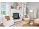Bright living area with a fireplace, matching white chairs, and great natural light at 1010 Elaine Ct, Mcdonough, GA 30252