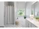Main bathroom showcasing a soaking tub, dual vanity, and bright natural light at 1010 Elaine Ct, Mcdonough, GA 30252