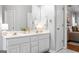 Bright primary bathroom with dual sinks, white cabinets, and neutral decor at 1010 Elaine Ct, Mcdonough, GA 30252