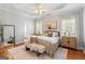 Spacious primary bedroom with a king bed, a large mirror, and modern decor at 1010 Elaine Ct, Mcdonough, GA 30252