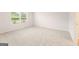 Spacious bedroom with neutral carpet and large windows, providing ample natural light at 8502 Polston Place # 144, Douglasville, GA 30134