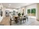 Bright dining room features a wood table, with views to an open kitchen and outdoor deck at 8502 Polston Place # 144, Douglasville, GA 30134