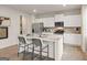 Modern kitchen with stainless steel appliances, white cabinets and a center island with bar stool seating at 8502 Polston Place # 144, Douglasville, GA 30134