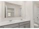 Bathroom featuring double sinks, modern gray vanity with white countertops, large mirror, and a shower-tub combo at 1949 Van Allen Ct # 4, Dacula, GA 30019