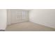 This bedroom features neutral carpet, white walls, baseboards and trim, plus a large window at 1949 Van Allen Ct # 4, Dacula, GA 30019