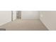 This bedroom features neutral carpet, white walls, baseboards and trim, plus a large window at 1949 Van Allen Ct # 4, Dacula, GA 30019