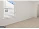 Well-lit bedroom with neutral carpet, a window, and a doorway to a closet at 1949 Van Allen Ct # 4, Dacula, GA 30019