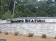 Brooks Station neighborhood sign in stone with manicured bushes, showing a welcoming community entrance at 1949 Van Allen Ct # 4, Dacula, GA 30019